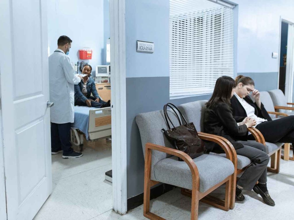 Two women looking fed up in waiting room